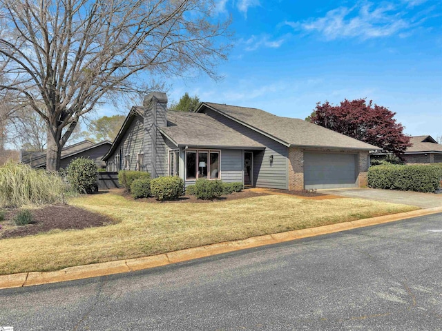 122 Tanager Cir, Greer, SC 29650 - view of front of home with an attached garage, driveway, a chimney, brick siding, and a front lawn