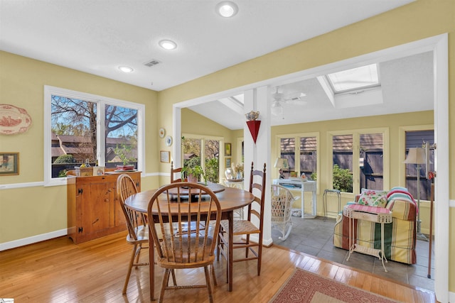122 Tanager Cir, Greer, SC 29650 - dining area with light wood finished floors, lofted ceiling, baseboards, a skylight, and ceiling fan