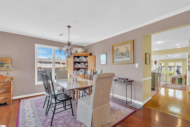 122 Tanager Cir, Greer, SC 29650 - dining area featuring hardwood / wood-style floors, a chandelier, crown molding, and baseboards