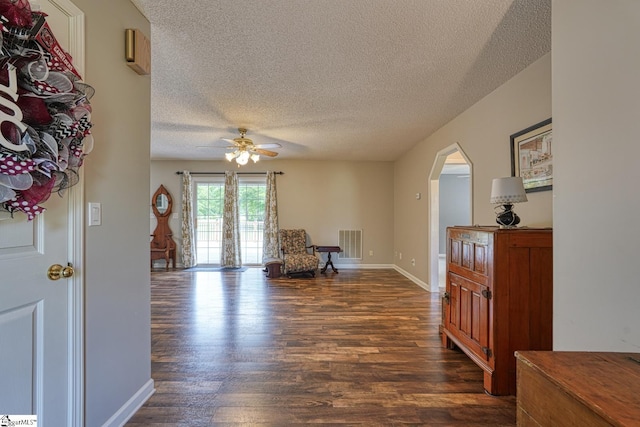 103 Cheyenne Ridge Rd, Campobello, SC 29322 - sitting room with a textured ceiling, dark wood-type flooring, arched walkways, ceiling fan, and baseboards