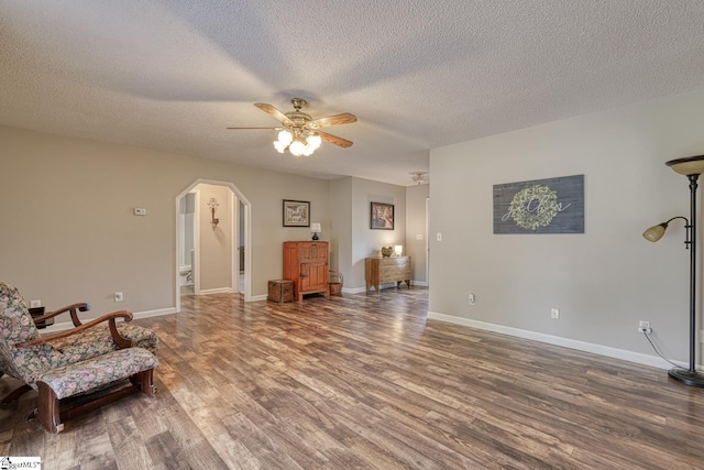 103 Cheyenne Ridge Rd, Campobello, SC 29322 - living area featuring wood finished floors, arched walkways, a ceiling fan, baseboards, and a textured ceiling