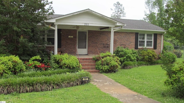 320 N Adair St, Clinton, SC 29325 - view of front of home featuring a front lawn, brick siding, a porch, and ceiling fan