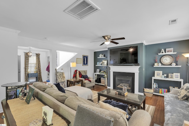 157 Stonewood Crossing Dr, Boiling Springs, SC 29316 - living room with crown molding, ceiling fan, a glass covered fireplace, and wood finished floors