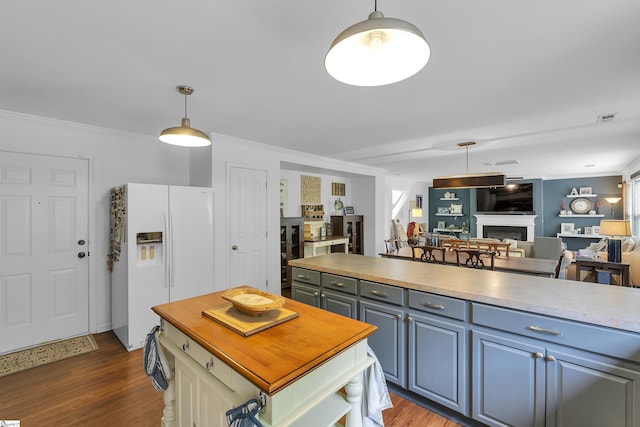157 Stonewood Crossing Dr, Boiling Springs, SC 29316 - kitchen with white refrigerator with ice dispenser, a fireplace, open floor plan, dark wood-style floors, and pendant lighting