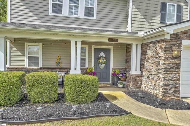 157 Stonewood Crossing Dr, Boiling Springs, SC 29316 - entrance to property with covered porch, stone siding, and a garage