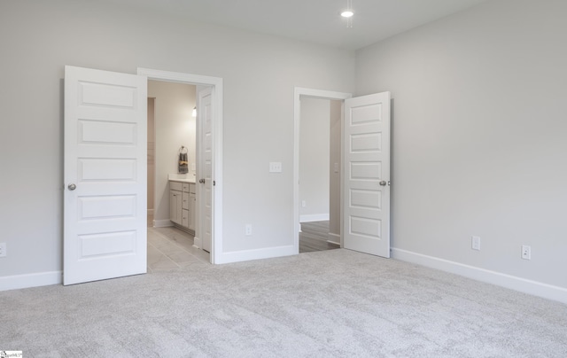 207 Fenner Pl, Greenville, SC 29607 - unfurnished bedroom featuring light carpet, baseboards, and connected bathroom