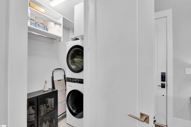laundry area featuring stacked washer and clothes dryer