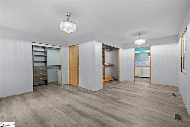 150 Orchard Dr, Inman, SC 29349 - unfurnished bedroom featuring a chandelier, wood finished floors, and connected bathroom