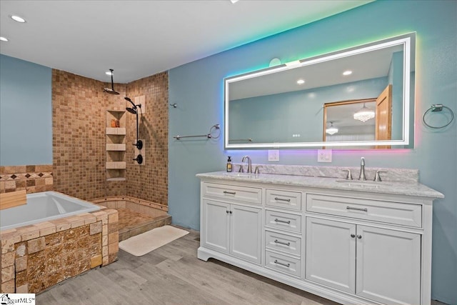 150 Orchard Dr, Inman, SC 29349 - full bath with wood finished floors, double vanity, a tile shower, a relaxing tiled tub, and recessed lighting