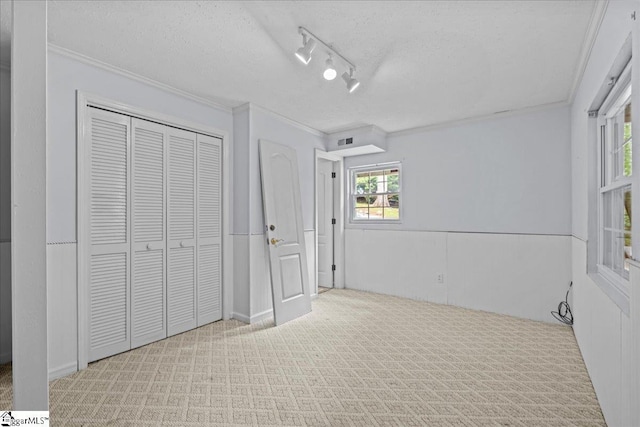 150 Orchard Dr, Inman, SC 29349 - unfurnished bedroom featuring ornamental molding, a textured ceiling, a closet, and carpet floors