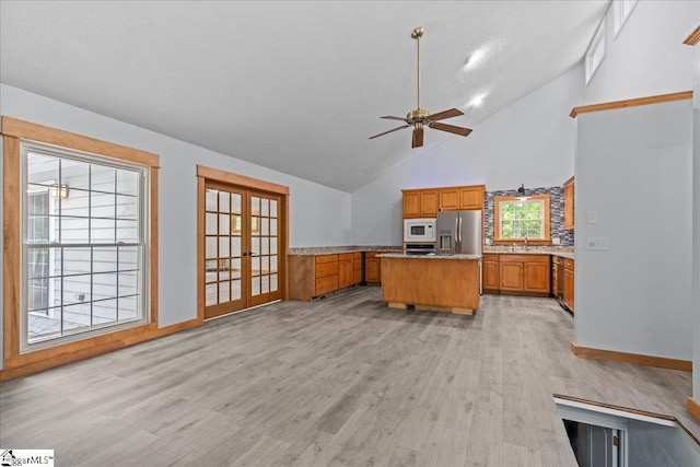 150 Orchard Dr, Inman, SC 29349 - kitchen featuring stainless steel fridge with ice dispenser, white microwave, brown cabinets, french doors, and light wood-style floors