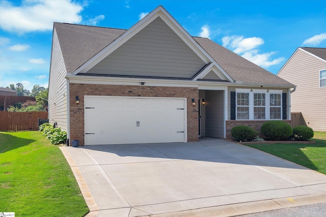 205 Hartwood Lake Ln, Greer, SC 29650 - view of front facade with brick siding, driveway, an attached garage, and roof with shingles