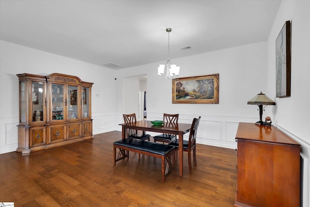 205 Hartwood Lake Ln, Greer, SC 29650 - dining room with a chandelier, a decorative wall, dark wood-style floors, and a wainscoted wall