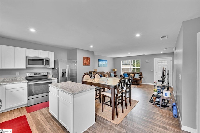 145 Queens Mill Ct, Pendleton, SC 29670 - kitchen featuring stainless steel appliances, open floor plan, light wood-type flooring, recessed lighting, and white cabinets