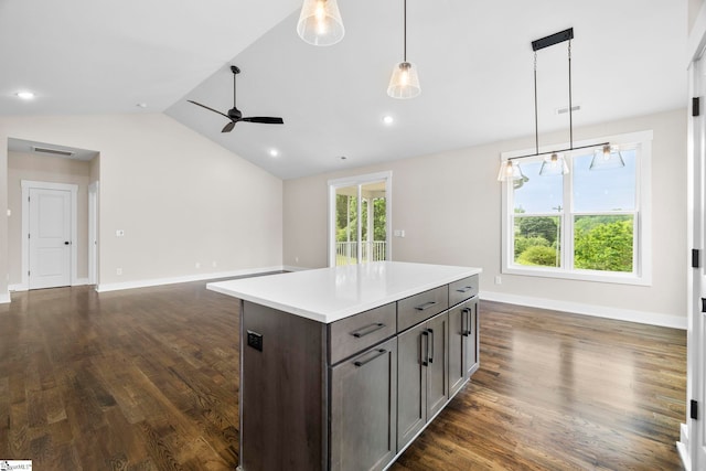 1047 Ansel School Rd, Greer, SC 29651 - kitchen with vaulted ceiling, dark wood-style flooring, ceiling fan, a kitchen island, and light countertops