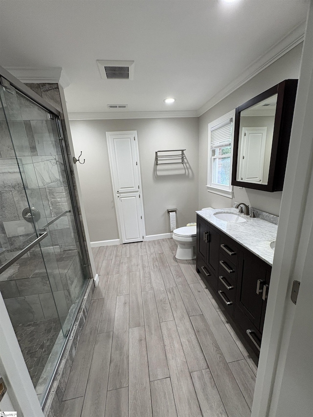 102 Quail Creek Ln, Greenville, SC 29615 - bathroom featuring ornamental molding, wood finished floors, a shower stall, toilet, and double vanity