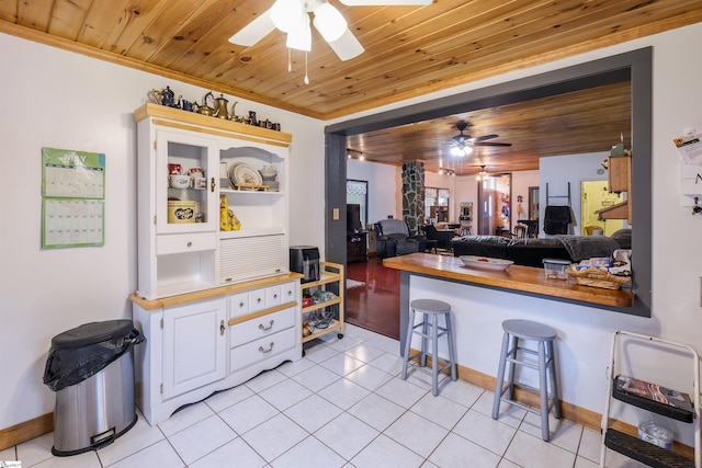 402 Terrapin Rd, Union, SC 29379 - kitchen featuring a ceiling fan, wooden ceiling, light tile patterned floors, decorative columns, and baseboards