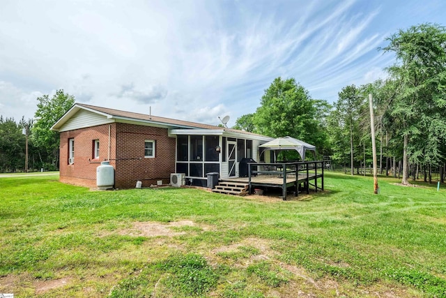 402 Terrapin Rd, Union, SC 29379 - rear view of house featuring a sunroom, brick siding, a wooden deck, and a yard