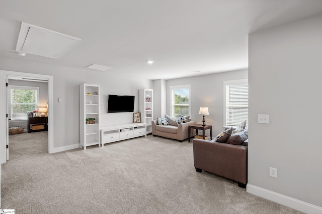 907 Whitemarsh Ave, Simpsonville, SC 29680 - living room featuring attic access, light carpet, baseboards, and healthy amount of natural light