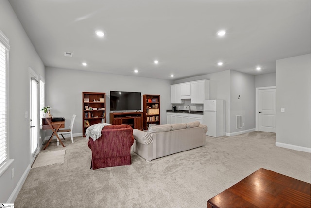 907 Whitemarsh Ave, Simpsonville, SC 29680 - living room with light colored carpet, baseboards, and recessed lighting