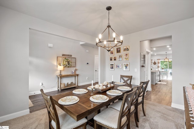 907 Whitemarsh Ave, Simpsonville, SC 29680 - dining area with a chandelier, baseboards, and light wood finished floors