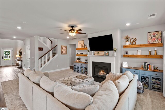 907 Whitemarsh Ave, Simpsonville, SC 29680 - living room with ceiling fan, recessed lighting, a glass covered fireplace, stairway, and baseboards