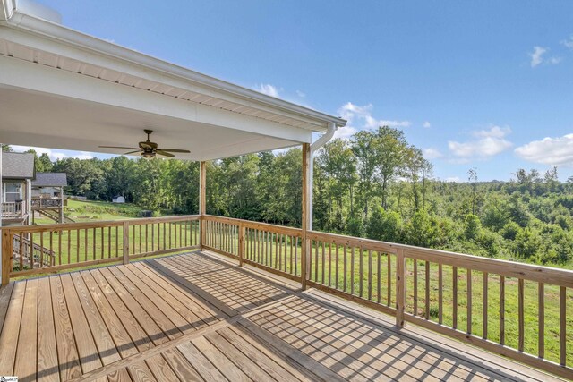 deck with ceiling fan and a lawn