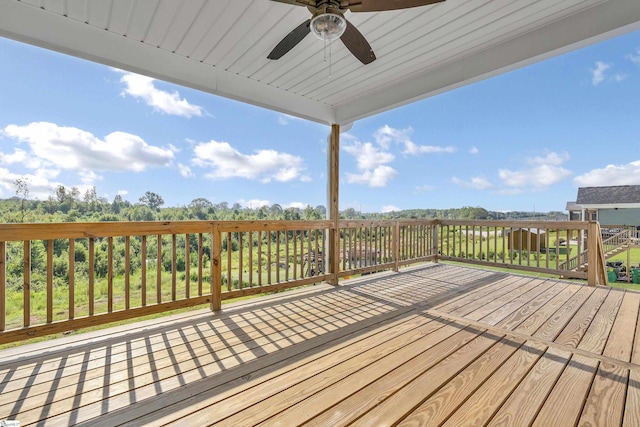 wooden deck featuring a ceiling fan