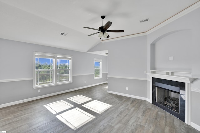 unfurnished living room with wood finished floors, a ceiling fan, lofted ceiling, a fireplace, and baseboards