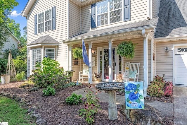 113 Faulkner Cir, Greer, SC 29651 - property entrance with covered porch, a shingled roof, and a garage