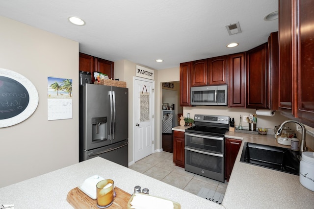 113 Faulkner Cir, Greer, SC 29651 - kitchen with appliances with stainless steel finishes, a sink, light countertops, reddish brown cabinets, and recessed lighting