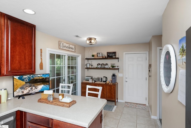 113 Faulkner Cir, Greer, SC 29651 - kitchen with a peninsula, light countertops, dark brown cabinets, baseboards, and light tile patterned flooring