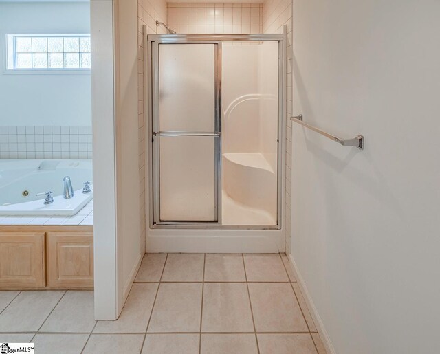 301 S Cassidy Way, Campobello, SC 29322 - bathroom with a shower stall, tile patterned floors, a jetted tub, and baseboards