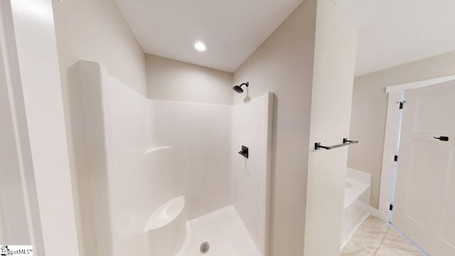bathroom with a shower, marble look tiles, and a bathtub