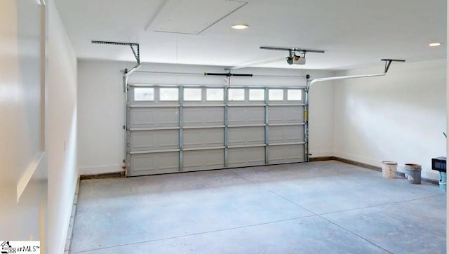 garage with a garage door opener, baseboards, and recessed lighting