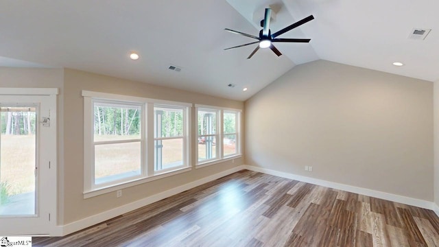 spare room featuring a ceiling fan, lofted ceiling, healthy amount of natural light, wood finished floors, and recessed lighting