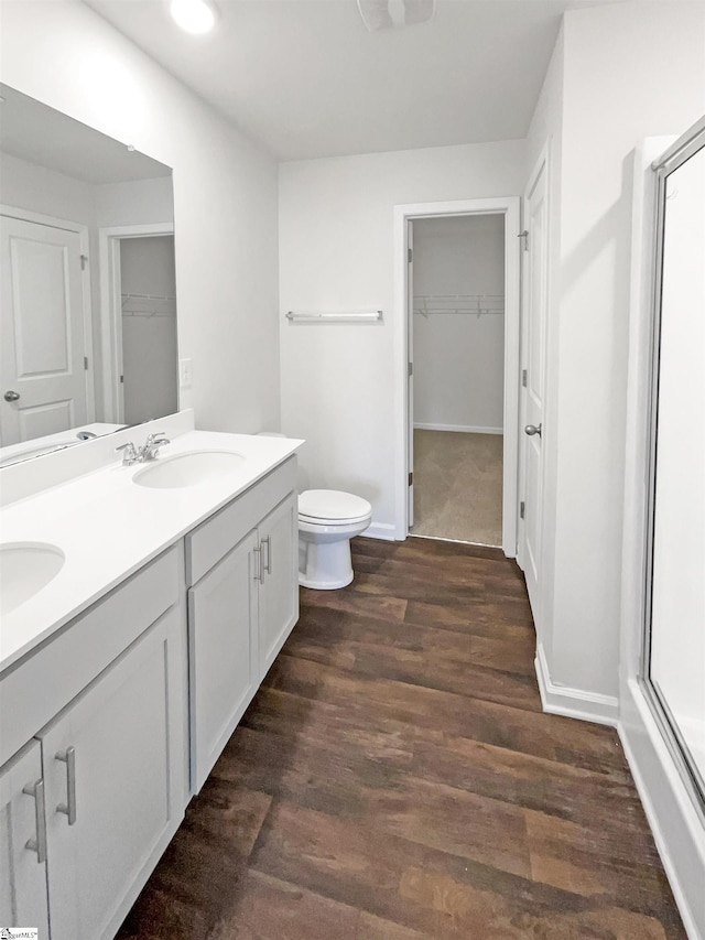 3740 Brookshade Trl, Moore, SC 29369 - full bath with wood finished floors, toilet, double vanity, a spacious closet, and baseboards