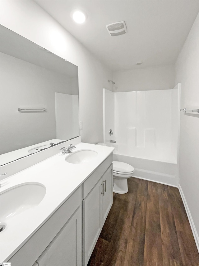 3740 Brookshade Trl, Moore, SC 29369 - full bathroom with wood finished floors, shower / washtub combination, double vanity, toilet, and baseboards