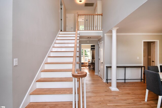 210 Cross Field Rd, Greenville, SC 29607 - staircase featuring crown molding, wood finished floors, a high ceiling, decorative columns, and baseboards