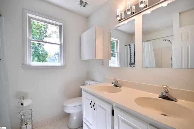 210 Cross Field Rd, Greenville, SC 29607 - bathroom featuring plenty of natural light, toilet, double vanity, and baseboards