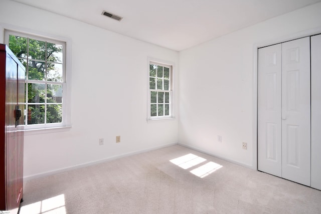 210 Cross Field Rd, Greenville, SC 29607 - unfurnished bedroom with multiple windows, carpet, and a closet