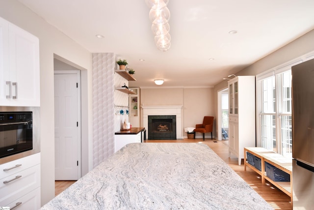 210 Cross Field Rd, Greenville, SC 29607 - bedroom featuring a fireplace with flush hearth, light wood-style floors, and freestanding refrigerator