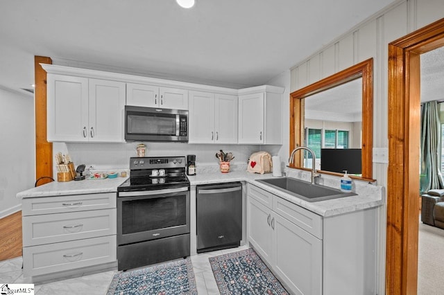 228 Styles Rd, Taylors, SC 29687 - kitchen featuring appliances with stainless steel finishes, a sink, white cabinetry, and light countertops