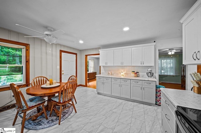 228 Styles Rd, Taylors, SC 29687 - kitchen with ceiling fan, white cabinetry, backsplash, stainless steel range with electric stovetop, and recessed lighting