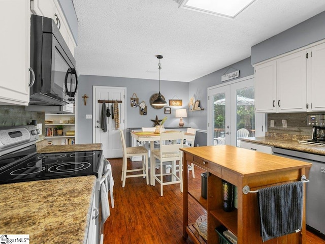 kitchen with range with electric stovetop, black microwave, white cabinetry, a textured ceiling, and french doors