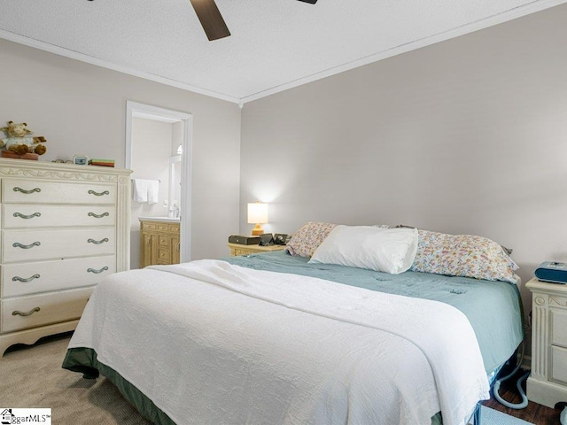 bedroom featuring ornamental molding, light colored carpet, ceiling fan, and connected bathroom