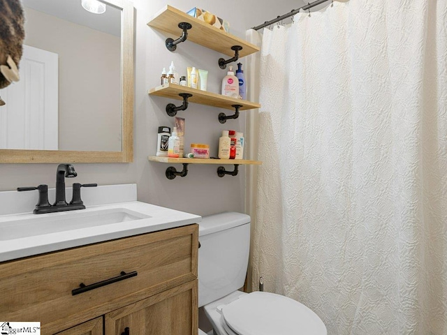 full bathroom featuring toilet and vanity