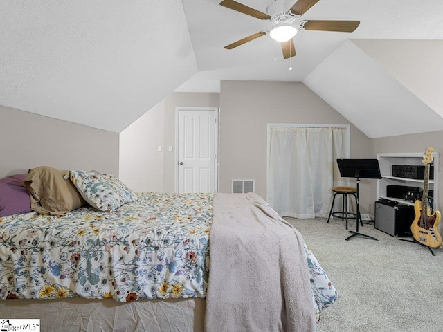 bedroom with carpet floors, lofted ceiling, and ceiling fan