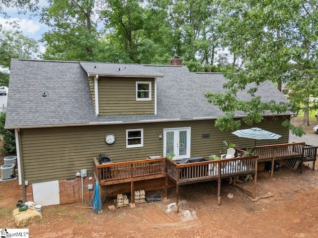 back of property with a deck, french doors, roof with shingles, a chimney, and central AC unit