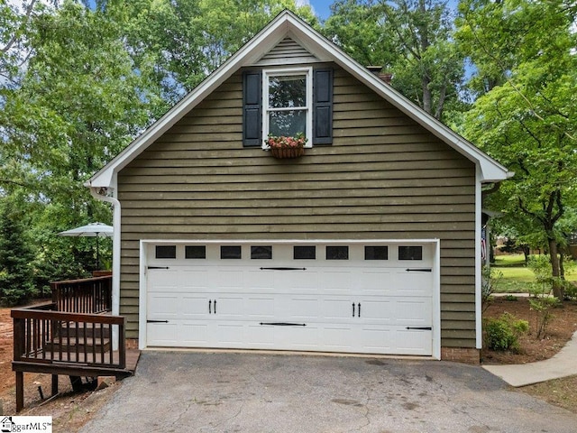 garage featuring asphalt driveway